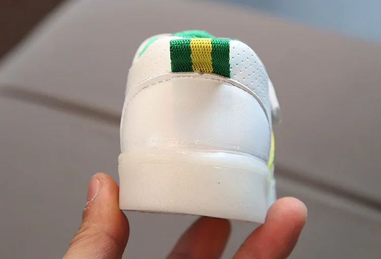White sneaker with green and yellow striped heel tab, leather material, casual fit