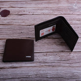 Dark brown textured leather bifold wallet with card slots on rustic wooden surface