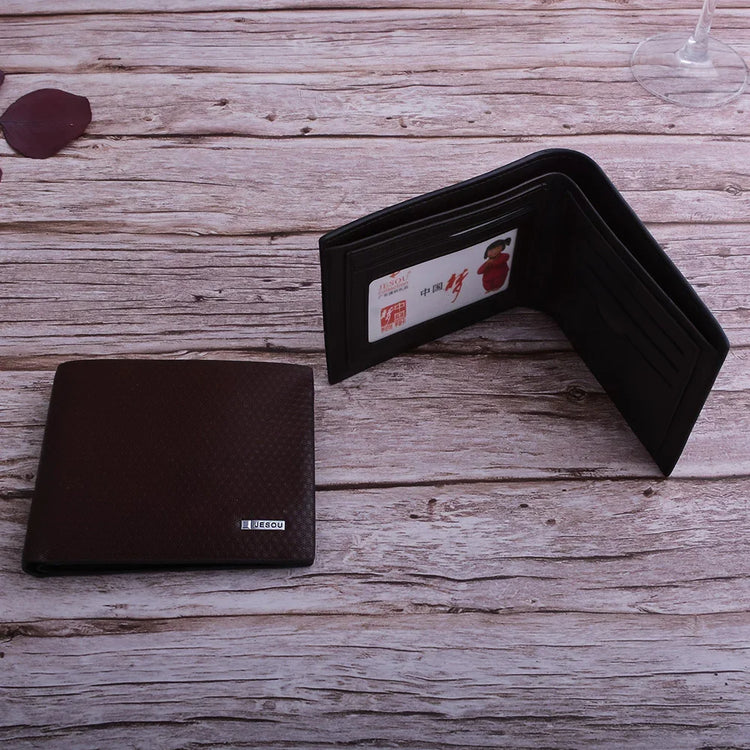 Dark brown textured leather bifold wallet with card slots on rustic wooden surface