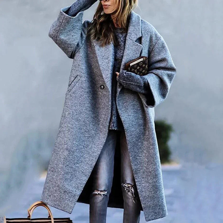 Woman wearing oversized gray wool coat, distressed jeans, relaxed street style fit