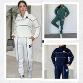 Women’s fleece tracksuits in white, green, and navy with zip collar, contrast piping, relaxed fit.