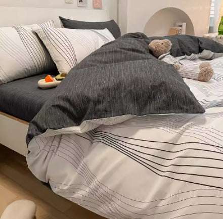 Cotton gradient color bed sheet set with dark and light striped design on a neatly made bed