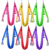 Assorted aerial yoga hammocks in pink, yellow, green, blue, red, and purple, soft fabric material, fitness accessory.