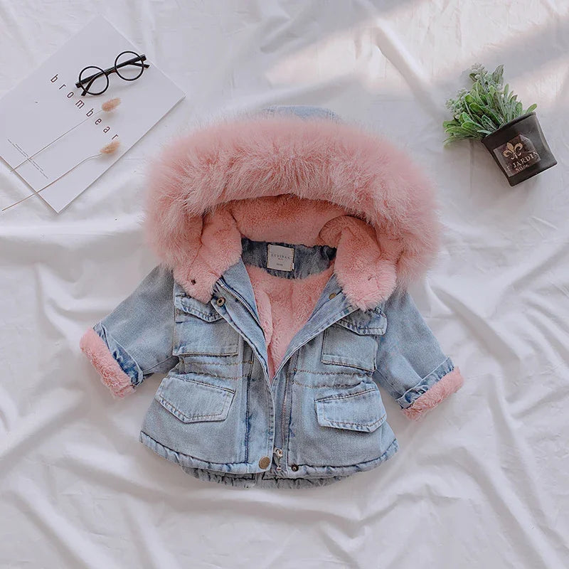Light blue denim jacket with pink faux fur lining and hood, long sleeves, and relaxed fit