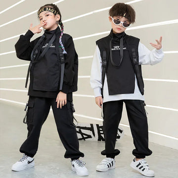 Kids in black and white streetwear sets with cargo pants, utility vests, and loose fit style