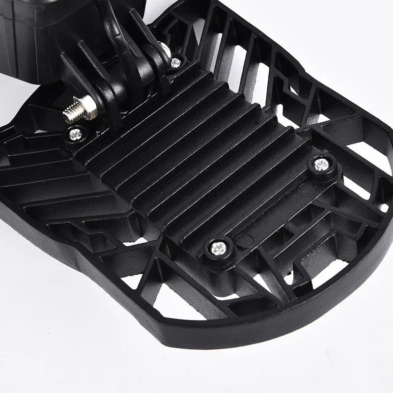 Close-up of black plastic textured accessory with geometric cutouts and screws