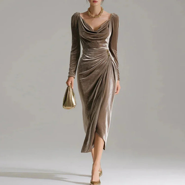 Woman wearing a taupe velvet draped midi dress with long sleeves and a fitted waist