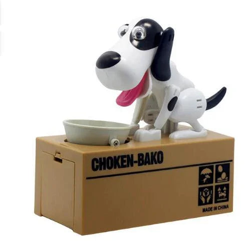 Black and white plastic dog coin bank toy on a brown rectangular box with a food bowl.