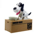 Black and white dog-shaped coin bank toy with moving parts on a brown box base.