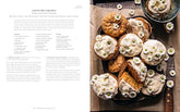Half Baked Harvest Quick & Cozy cookbook open to carrot cake cupcakes recipe with decorated cupcakes on wooden board