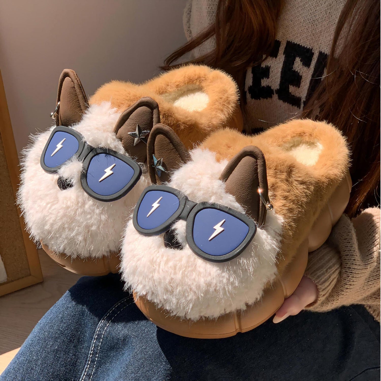 Cute plush animal slippers in brown and white with fuzzy texture and fun sunglasses detail.