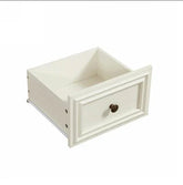 White wooden drawer with decorative panel and round metal handle