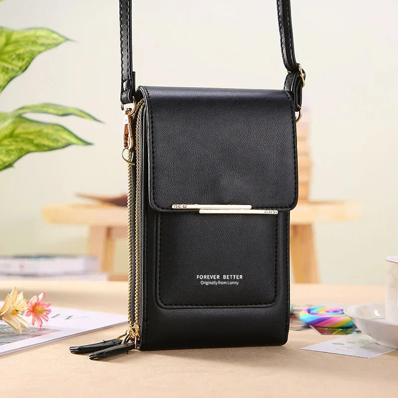 Black faux leather crossbody bag with gold zippers, compact design, slim fit, flap closure