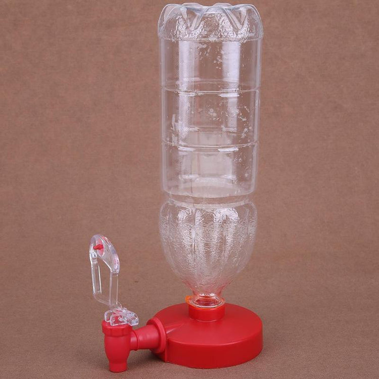 Clear plastic bottle with red base and spout, used as a water dispenser, on brown background.
