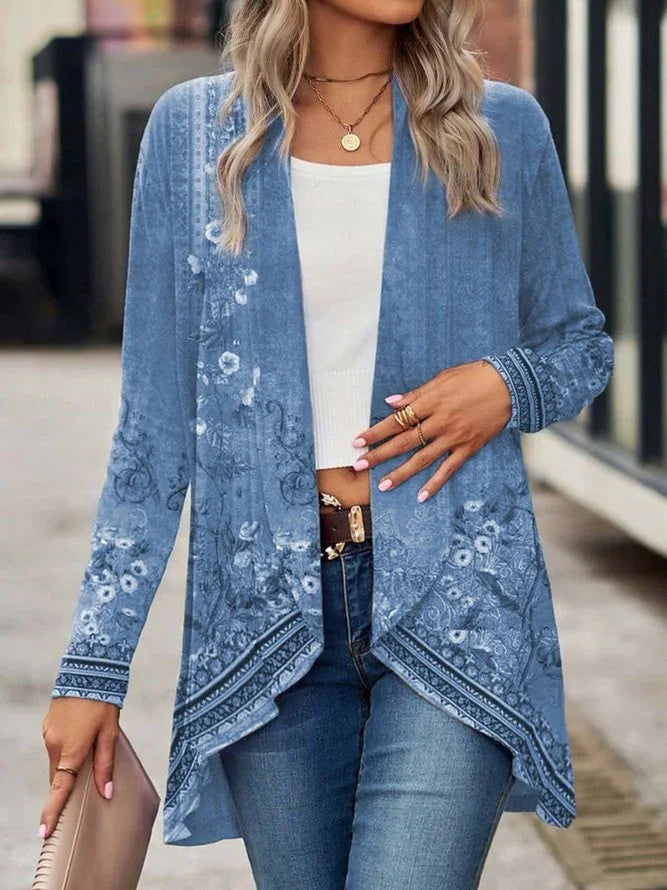 Light blue floral patterned open-front cardigan with long sleeves and relaxed fit, styled with a white top and jeans.