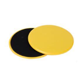 Pair of round yellow and black plastic exercise sliders on white background
