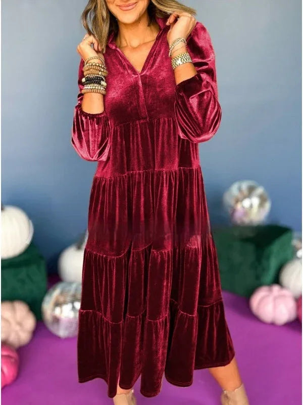 Woman wearing a long-sleeve velvet burgundy tiered midi dress with relaxed fit
