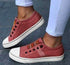 Red canvas slip-on sneakers with striped elastic bands and white soles, casual fit