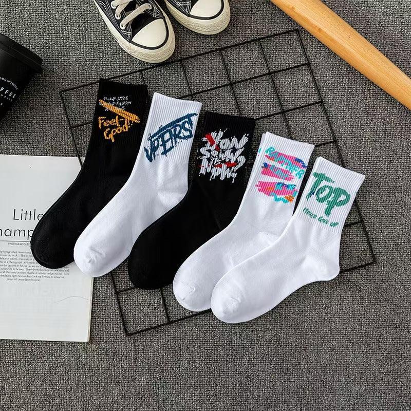 Assorted graphic crew socks in black and white, cotton material, streetwear style.