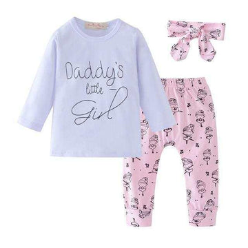 Girls' pastel pajama set with long-sleeve white top, pink printed pants, and matching headband