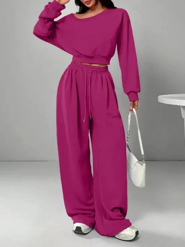 Woman in magenta oversized sweatshirt and wide-leg pants set, relaxed fit, casual streetwear style