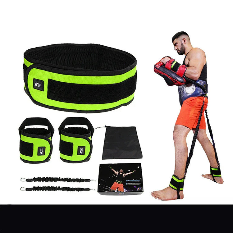Man wearing black tank top and orange athletic shorts, using neon green resistance training gear set.