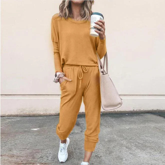 Woman wearing mustard yellow long sleeve knit jogger set, relaxed fit, streetwear style