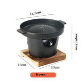 Small black round tabletop grill with wooden base, non-stick cast iron, compact size.