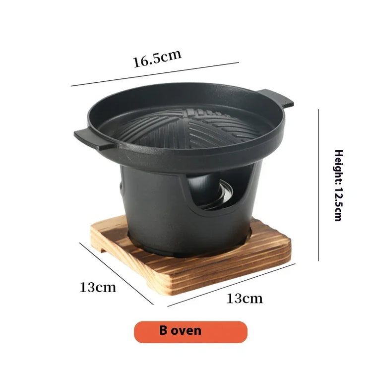 Small black round tabletop grill with wooden base, non-stick cast iron, compact size.