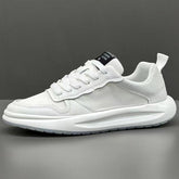 White low-top sneaker with mesh and textured leather panels, thick sole, modern fit