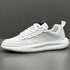 White low-top sneaker with mesh and textured leather panels, thick sole, modern fit