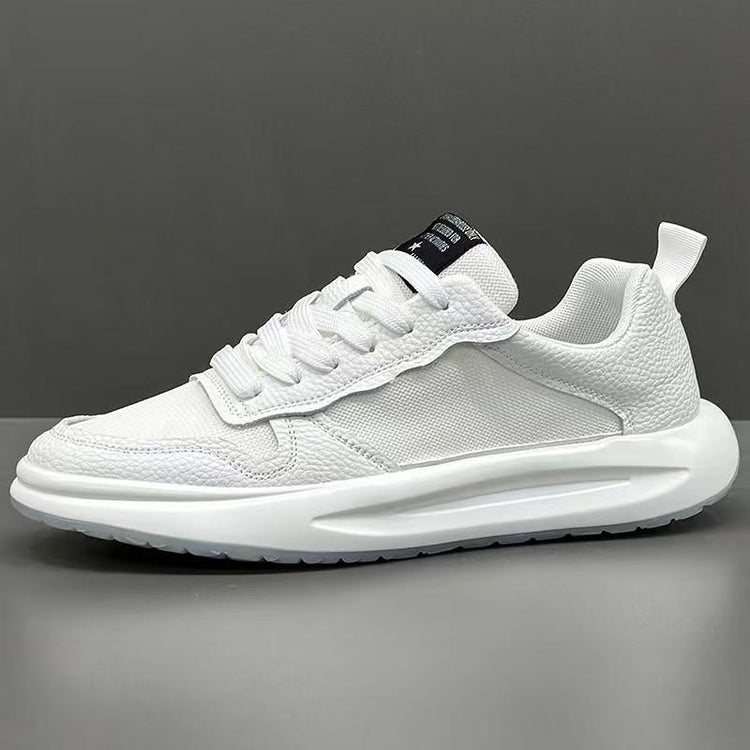 White low-top sneaker with mesh and textured leather panels, thick sole, modern fit