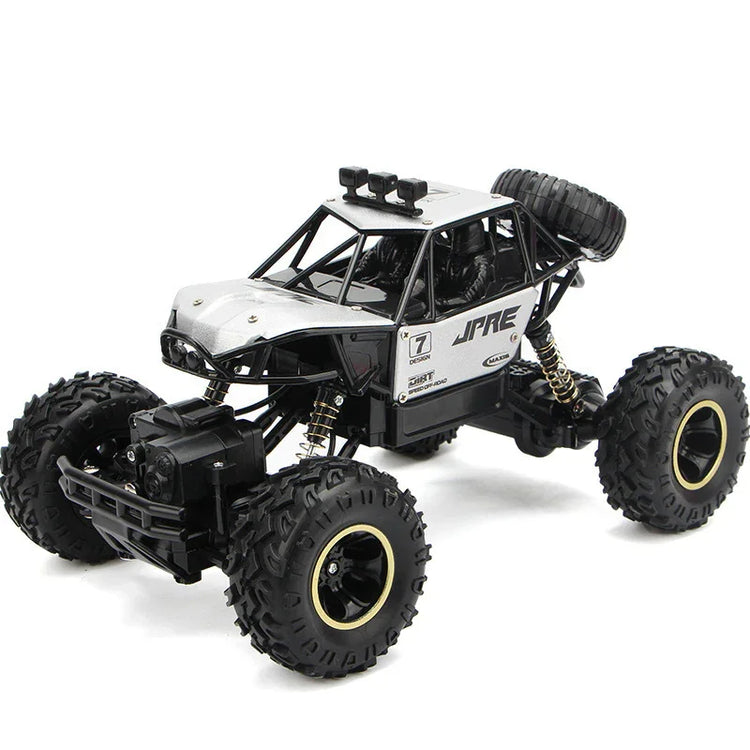 Silver and black off-road RC car with large rugged tires and open roll cage design.