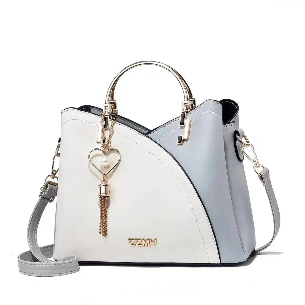 Chic two-tone white and gray handbag with gold hardware, heart charm, and adjustable strap