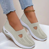 Beige knit slip-on sneakers with cutout design, breathable mesh material, and white soles