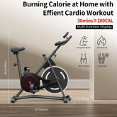 Black indoor cycling exercise bike with adjustable seat and multi-function display, set in a modern room with wooden floor.