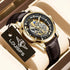 Gold skeleton mechanical wristwatch with black leather strap and diamond hour markers