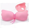Pink silicone strapless bra with lace-up front, soft material, and winged design for seamless fit