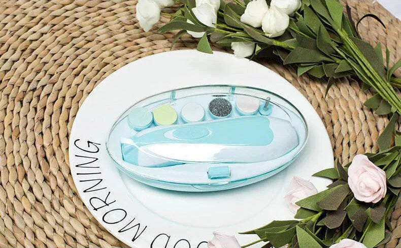 Light blue and white manicure set with multiple nail care tools in a clear case on a woven mat