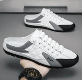 White and gray low-top slip-on sneakers with black accents, quilted texture, and casual fit