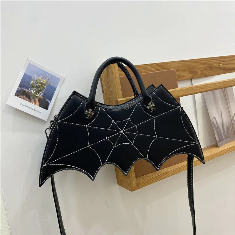 Black bat-shaped handbag with white spiderweb stitching, faux leather, structured fit