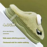 Fuzzy beige slipper with thick olive green EVA sole, cartoon embroidery, and stable fit.