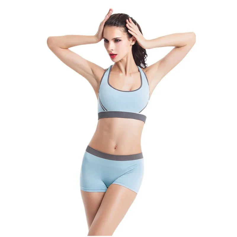 Woman wearing light blue seamless athletic sports bra and shorts set with grey trim