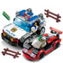 Plastic building block toy police vehicle and red sports car with mini figures and road barriers