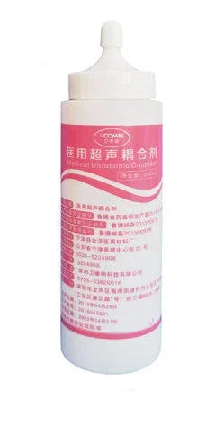 White and pink plastic bottle of ultrasound gel with flip-top cap, medical label in Chinese.