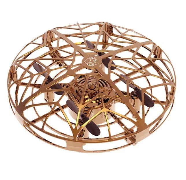 Gold metallic drone with cage design and black propellers, futuristic tech gadget