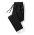 Black drawstring jogger pants with relaxed fit and zippered pockets, soft fabric