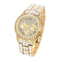 Gold-tone luxury watch with crystal accents, Roman numerals, and a metallic link band.