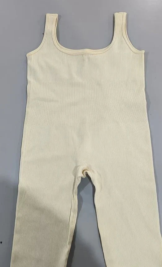 Beige ribbed knit jumpsuit with wide straps, sleeveless, slim fit streetwear style.