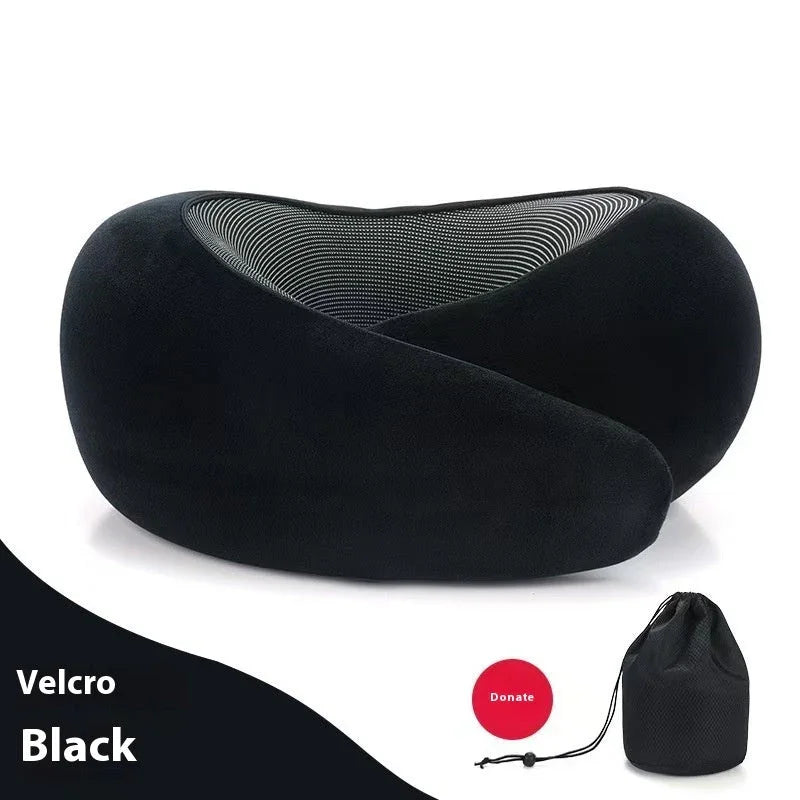 Black ergonomic travel neck pillow with soft velvety fabric and mesh lining, includes storage bag